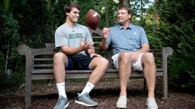 Christ School senior quarterback Navy Shuler and his dad, former NFL quarterback Heath Shuler, in the backyard of their home on July 2, 2019. 

Tab Shuler 02