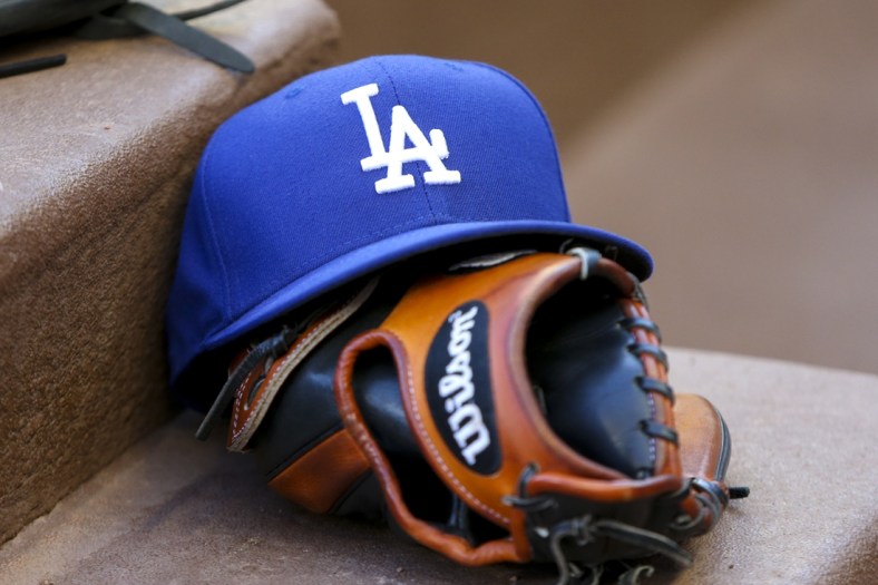 Aug 16, 2019; Atlanta, GA, USA; Detailed view of Los Angeles Dodgers hat and glove in the dugout against the Atlanta Braves in the first inning at SunTrust Park. Mandatory Credit: Brett Davis-USA TODAY Sports