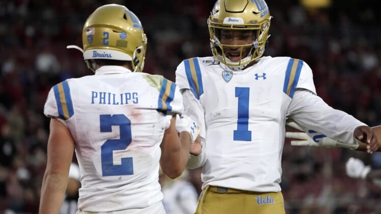 Oct 17, 2019; Stanford, CA, USA; UCLA Bruins quarterback Dorian Thompson-Robinson (1) and wide receiver Kyle Philips (2) celebrate after a touchdown in the first half against the Stanford Cardinal at Stanford Stadium. Mandatory Credit: Kirby Lee-USA TODAY Sports