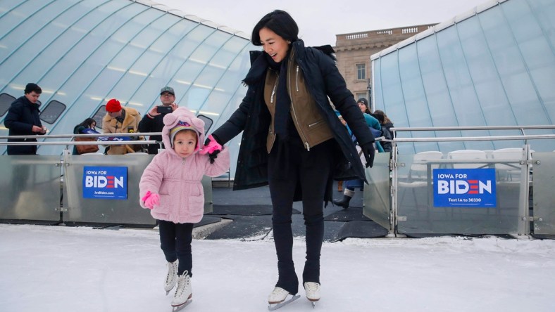 Avery Collins, 4, of Waukee leads Olympic figure skater Michelle Kwan onto the ice at Brenton Skating Plaza in Des Moines on Saturday, Dec. 14, 2019. Kwan, a supporter of Vice President Joe Biden, was in town to fire up support for Biden's run to be the democratic presidential candidate.

20191214 Michellekwan