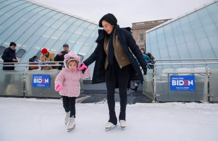 Avery Collins, 4, of Waukee leads Olympic figure skater Michelle Kwan onto the ice at Brenton Skating Plaza in Des Moines on Saturday, Dec. 14, 2019. Kwan, a supporter of Vice President Joe Biden, was in town to fire up support for Biden's run to be the democratic presidential candidate.

20191214 Michellekwan