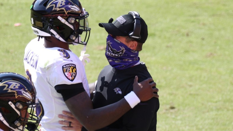 Oct 4, 2020; Landover, Maryland, USA; Baltimore Ravens quarterback Lamar Jackson (8) hugs Ravens head coach John Harbaugh (R) after scoring a touchdown against the Washington Football Team at FedExField. Mandatory Credit: Geoff Burke-USA TODAY Sports