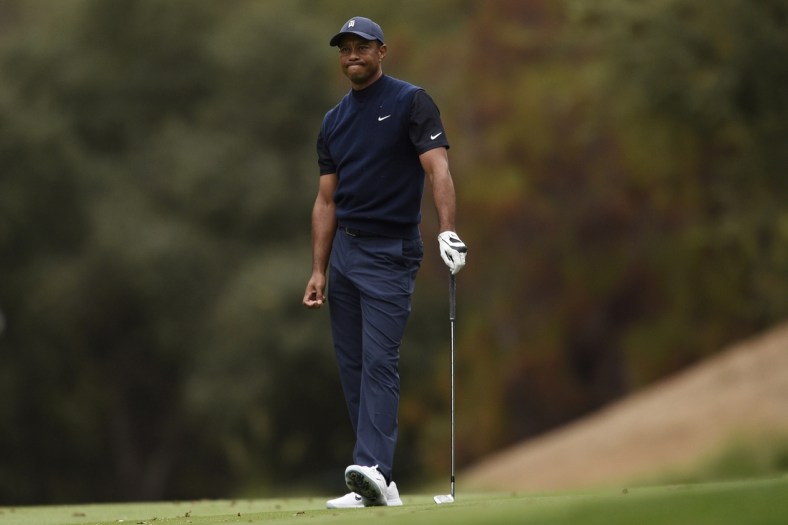 Oct 24, 2020; Thousand Oaks, California, USA; Tiger Woods reacts to his fairway shot on the 18th hole during the third round of the Zozo Championship golf tournament at Sherwood Country Club. Mandatory Credit: Kelvin Kuo-USA TODAY Sports