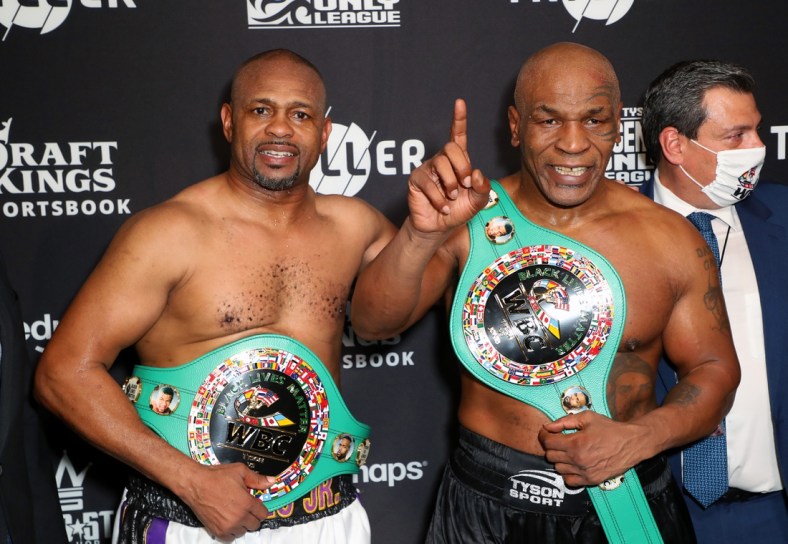 Nov 28, 2020; Los Angeles, CA, USA;  Mike Tyson and Roy Jones, Jr. pose with their belts after a split draw during a heavyweight exhibition boxing bout for the WBC Frontline Belt at the Staples Center.  Mandatory Credit: Joe Scarnici/Handout Photo via USA TODAY Sports