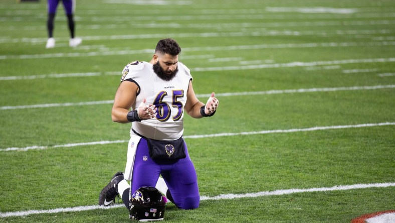 Dec 14, 2020; Cleveland, Ohio, USA; Baltimore Ravens offensive guard Patrick Mekari (65) kneels in the end zone before the game against the Cleveland Browns at FirstEnergy Stadium. Mandatory Credit: Scott Galvin-USA TODAY Sports