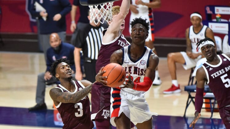Jan 23, 2021; Oxford, Mississippi, USA; Mississippi Rebels guard Jarkel Joiner (24) lays the ball up against Texas A&M Aggies guard Quenton Jackson (3) during the second half at The Pavilion at Ole Miss. Mandatory Credit: Justin Ford-USA TODAY Sports