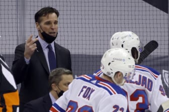 Mar 9, 2021; Pittsburgh, Pennsylvania, USA;  New York Rangers head coach David Quinn (left) talks to his team during a time-out against the Pittsburgh Penguins in the third period at PPG Paints Arena. The Penguins won 4-2. Mandatory Credit: Charles LeClaire-USA TODAY Sports
