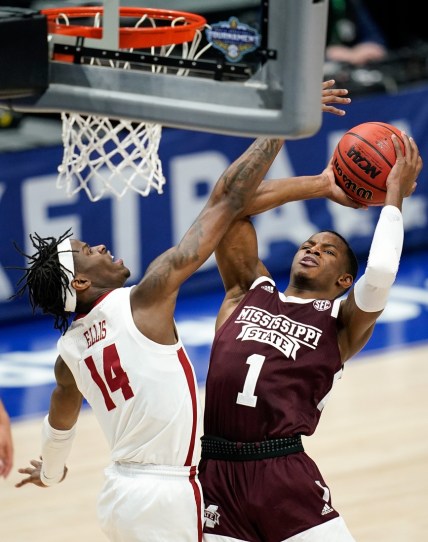 Alabama guard Keon Ellis (14) blocks a shot from Mississippi State guard Iverson Molinar (1) during the first half of the SEC Men's Basketball Tournament game at Bridgestone Arena in Nashville, Tenn., Friday, March 12, 2021.

Ms Ala Sec 031221 An 017