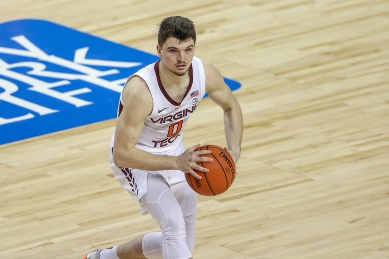 Mar 11, 2021; Greensboro, North Carolina, USA; Virginia Tech Hokies guard Hunter Cattoor (0) looks to pass against the North Carolina Tar Heels in the quarterfinal round of the 2021 ACC tournament at Greensboro Coliseum. The North Carolina Tar Heels won 81-73. Mandatory Credit: Nell Redmond-USA TODAY Sports