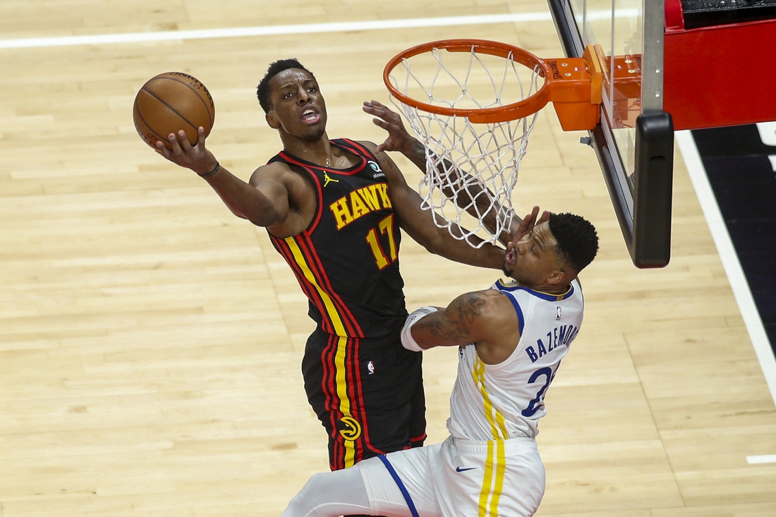 Apr 4, 2021; Atlanta, Georgia, USA; Atlanta Hawks forward Onyeka Okongwu (17) shoots past Golden State Warriors forward Kent Bazemore (26) in the third quarter at State Farm Arena. Mandatory Credit: Brett Davis-USA TODAY Sports