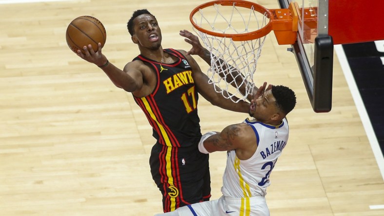 Apr 4, 2021; Atlanta, Georgia, USA; Atlanta Hawks forward Onyeka Okongwu (17) shoots past Golden State Warriors forward Kent Bazemore (26) in the third quarter at State Farm Arena. Mandatory Credit: Brett Davis-USA TODAY Sports