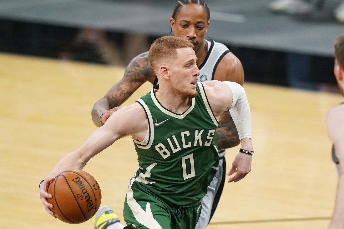 May 10, 2021; San Antonio, Texas, USA; Milwaukee Bucks guard Donte DiVincenzo (0) dribbles past San Antonio Spurs forward DeMar DeRozan (10) in the first half at the AT&T Center. Mandatory Credit: Daniel Dunn-USA TODAY Sports