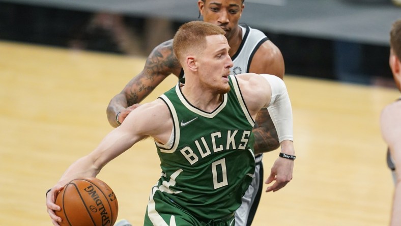 May 10, 2021; San Antonio, Texas, USA; Milwaukee Bucks guard Donte DiVincenzo (0) dribbles past San Antonio Spurs forward DeMar DeRozan (10) in the first half at the AT&T Center. Mandatory Credit: Daniel Dunn-USA TODAY Sports