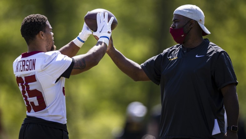 May 14, 2021; Ashburn, Virginia, USA; Washington Football Team running back Jaret Patterson (35) receives instruction from running backs coach Randy Jordan during rookie minicamp at Inova Sports Performance Center. Mandatory Credit: Scott Taetsch-USA TODAY Sports