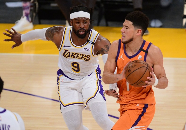 May 30, 2021; Los Angeles, California, USA; Phoenix Suns guard Devin Booker (1) moves to the basket against Los Angeles Lakers guard Wesley Matthews (9) during the first half in game four of the first round of the 2021 NBA Playoffs. at Staples Center. Mandatory Credit: Gary A. Vasquez-USA TODAY Sports