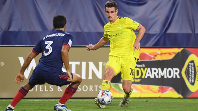 Jul 17, 2021; Nashville, TN, USA; Nashville SC defender Dylan Nealis (18) passes the ball while defended by Chicago Fire defender Jonathan Bornstein (3) during the second half at Nissan Stadium. Mandatory Credit: Christopher Hanewinckel-USA TODAY Sports