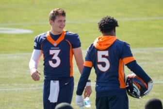 Jul 28, 2021; Englewood, CO, United States; Denver Broncos quarterback Drew Lock (left) talks with quarterback Teddy Bridgewater (right) during training camp at UCHealth Training Complex.