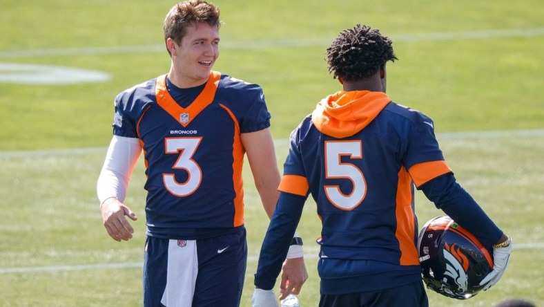 Jul 28, 2021; Englewood, CO, United States; Denver Broncos quarterback Drew Lock (left) talks with quarterback Teddy Bridgewater (right) during training camp at UCHealth Training Complex.