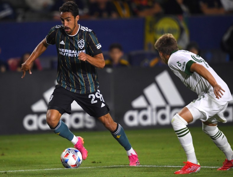 Jul 30, 2021; Carson, California, USA; Portland Timbers midfielder Blake Bodily (98) defends Los Angeles Galaxy forward Ethan Zubak (29) as he takes the ball to the goal in the second half of the game at StubHub Center. Mandatory Credit: Jayne Kamin-Oncea-USA TODAY Sports