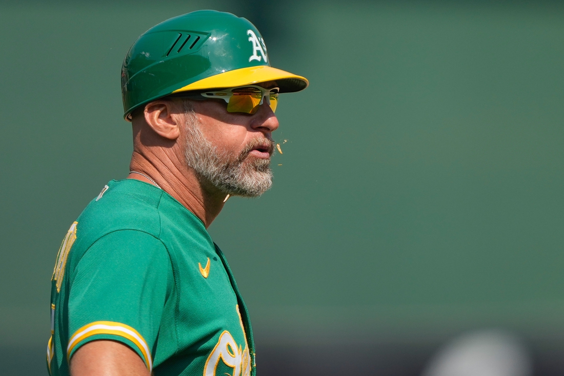 Aug 8, 2021; Oakland, California, USA;  Oakland Athletics third base coach Mark Kotsay (7) spits out sunflower seeds during the eighth inning against the Texas Rangers at RingCentral Coliseum. Mandatory Credit: Stan Szeto-USA TODAY Sports