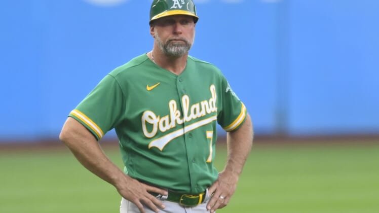 Aug 10, 2021; Cleveland, Ohio, USA; Oakland Athletics third base coach Mark Kotsay (7) stands on the field during a game against the Cleveland Indians at Progressive Field. Mandatory Credit: David Richard-USA TODAY Sports
