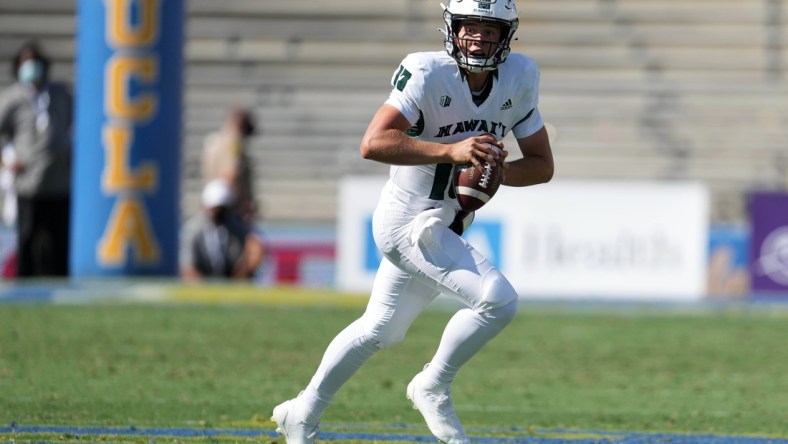 Aug 28, 2021; Pasadena, California, USA; Hawaii Rainbow Warriors  quarterback Brayden Schager (13) drops back to pass in the fourth quarter against the UCLA Bruinsat Rose Bowl. Mandatory Credit: Kirby Lee-USA TODAY Sports