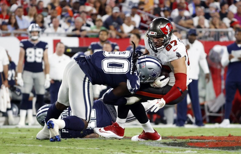 Sep 9, 2021; Tampa, Florida, USA; Tampa Bay Buccaneers tight end Rob Gronkowski (87) catches the ball against Dallas Cowboys defensive end DeMarcus Lawrence (90) during the first half at Raymond James Stadium. Mandatory Credit: Kim Klement-USA TODAY Sports