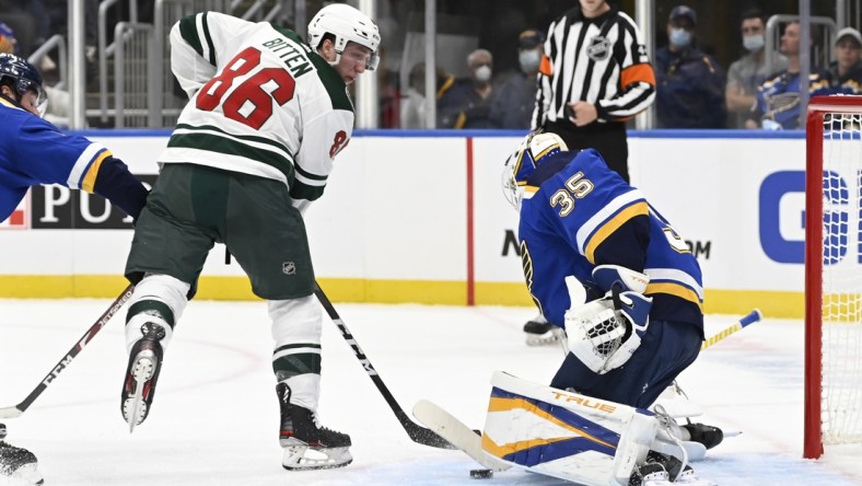 Sep 25, 2021; St. Louis, Missouri, USA; St. Louis Blues goaltender Ville Husso (35) makes a save against Minnesota Wild forward William Bitten (86) in the first period at Enterprise Center. Mandatory Credit: Jeff Le-USA TODAY Sports