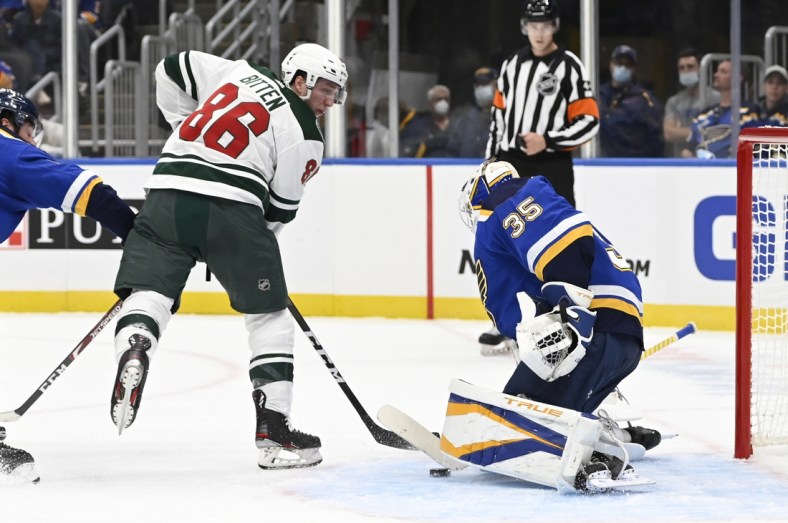 Sep 25, 2021; St. Louis, Missouri, USA; St. Louis Blues goaltender Ville Husso (35) makes a save against Minnesota Wild forward William Bitten (86) in the first period at Enterprise Center. Mandatory Credit: Jeff Le-USA TODAY Sports