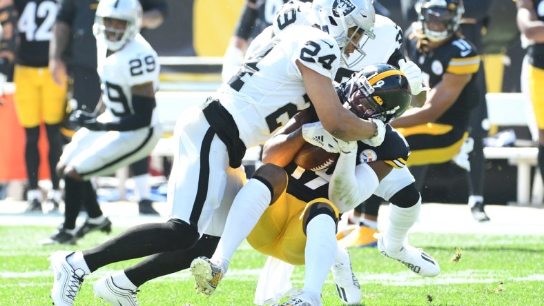 Sep 19, 2021; Pittsburgh, Pennsylvania, USA; Las Vegas Raiders safety Jonathan Abram tackles Pittsburgh Steelers wide receiver JuJu Smith-Schuster after a five yard gain in the first qwuarter at Heinz Field. Mandatory Credit: Philip G. Pavely-USA TODAY Sports