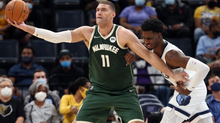 Oct 5, 2021; Memphis, Tennessee, USA; Milwaukee Bucks center Brook Lopez (11) fights for position against Memphis Grizzles forward Jaren Jackson Jr. (13) during the first half at FedExForum. Mandatory Credit: Petre Thomas-USA TODAY Sports