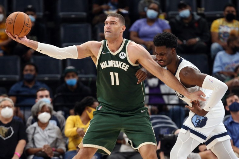 Oct 5, 2021; Memphis, Tennessee, USA; Milwaukee Bucks center Brook Lopez (11) fights for position against Memphis Grizzles forward Jaren Jackson Jr. (13) during the first half at FedExForum. Mandatory Credit: Petre Thomas-USA TODAY Sports