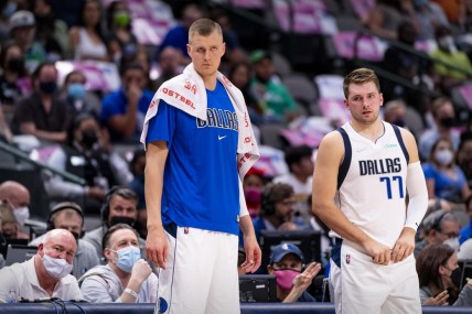 Oct 6, 2021; Dallas, Texas, USA; Dallas Mavericks center Kristaps Porzingis (6) and guard Luka Doncic (77) watch their team take on the Utah Jazz during the first half at the American Airlines Center. Mandatory Credit: Jerome Miron-USA TODAY Sports