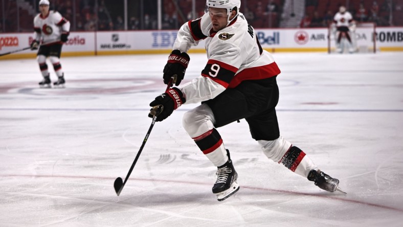 Oct 7, 2021; Montreal, Quebec, CAN; Ottawa Senators center Josh Norris (9) plays the puck against Montreal Canadiens during the first period at Bell Centre. Mandatory Credit: Jean-Yves Ahern-USA TODAY Sports