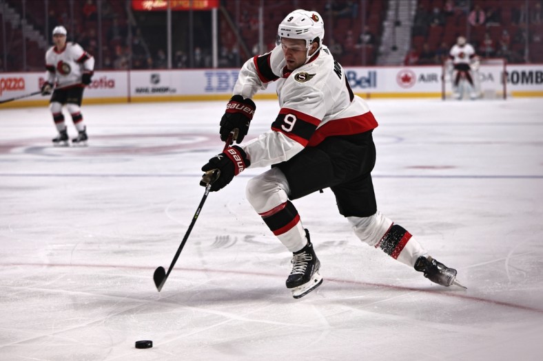 Oct 7, 2021; Montreal, Quebec, CAN; Ottawa Senators center Josh Norris (9) plays the puck against Montreal Canadiens during the first period at Bell Centre. Mandatory Credit: Jean-Yves Ahern-USA TODAY Sports