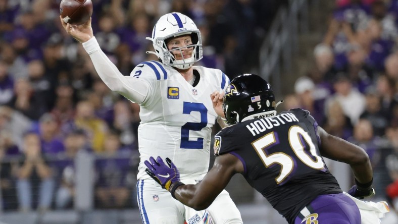 Oct 11, 2021; Baltimore, Maryland, USA; Indianapolis Colts quarterback Carson Wentz (2) passes the ball under pressure from Baltimore Ravens outside linebacker Justin Houston (50) during the first quarter at M&T Bank Stadium. Mandatory Credit: Geoff Burke-USA TODAY Sports