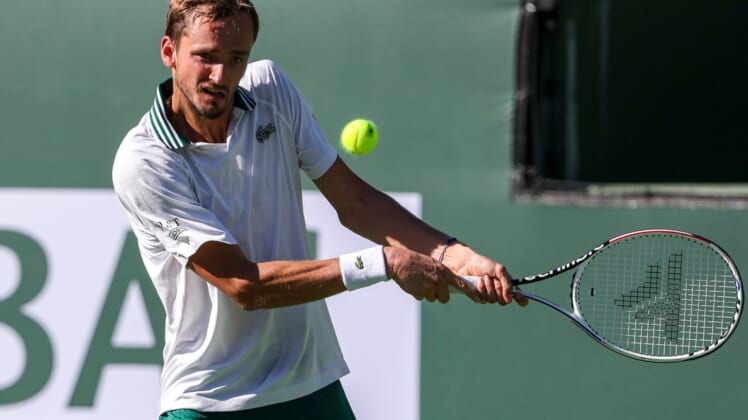 Daniil Medvedev of Russia returns to Grigor Dimitrov of Bulgaria during their round four match of the BNP Paribas Open, Wednesday, Oct. 13, 2021, in Indian Wells, Calif.