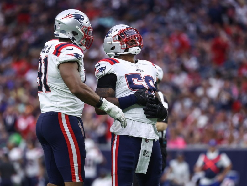 Oct 10, 2021; Houston, Texas, USA; New England Patriots inside linebacker Jamie Collins (58) reacts with defensive end Deatrich Wise (91) after getting a sack during the fourth quarter against the Houston Texans at NRG Stadium. Mandatory Credit: Troy Taormina-USA TODAY Sports