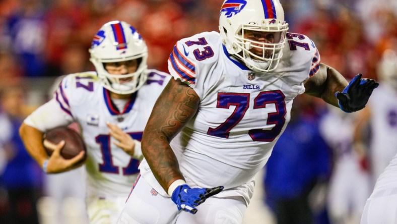 Oct 10, 2021; Kansas City, Missouri, USA; Buffalo Bills offensive tackle Dion Dawkins (73) gets ready to block for quarterback Josh Allen (17) during the first half against the Kansas City Chiefs at GEHA Field at Arrowhead Stadium. Mandatory Credit: Jay Biggerstaff-USA TODAY Sports