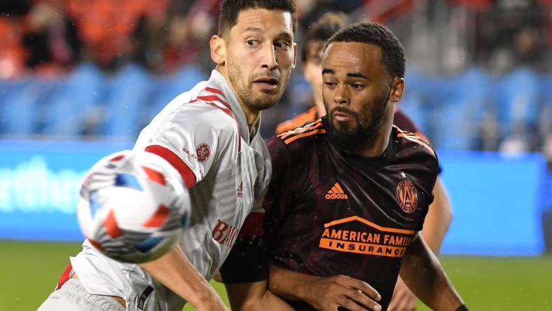 Oct 16, 2021; Toronto, Ontario, CAN;   Toronto FC defender Omar Gonzalez (44) watches his saved header bounce away from Atlanta United defender Anton Walkes (4) in the second half at BMO Field. Mandatory Credit: Dan Hamilton-USA TODAY Sports