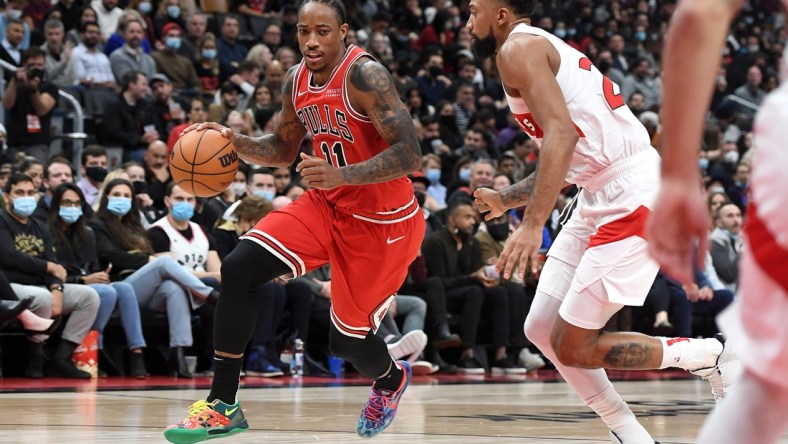 Oct 25, 2021; Toronto, Ontario, CAN; Chicago Bulls guard DeMar DeRozan (11) dribbles the ball past Toronto Raptors center Khem Birch (24) in the second half at Scotiabank Arena. Mandatory Credit: Dan Hamilton-USA TODAY Sports