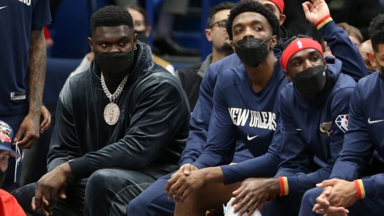 Oct 29, 2021; New Orleans, Louisiana, USA; Injured New Orleans Pelicans forward Zion Williamson, wearing necklace, sits on the bench in the second quarter of their game against the Sacramento Kings at the Smoothie King Center. Mandatory Credit: Chuck Cook-USA TODAY Sports
