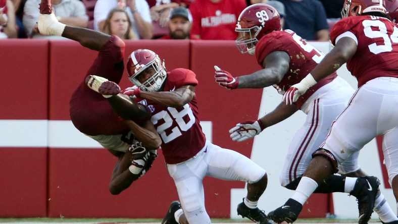 Alabama defensive back Josh Jobe (28) upends a New Mexico State running back during the second half of Alabama's 62-10 victory over New Mexico State in Bryant-Denny Stadium Saturday, Sep. 7, 2019. [Staff Photo/Gary Cosby Jr.]

Alabama Vs New Mexico State