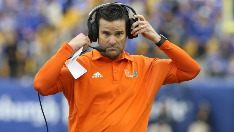 Oct 30, 2021; Pittsburgh, Pennsylvania, USA;  Miami Hurricanes head coach Manny Diaz puts his headset on against the Pittsburgh Panthers during the fourth quarter at Heinz Field. Mandatory Credit: Charles LeClaire-USA TODAY Sports