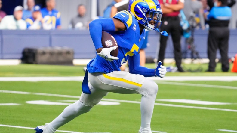 Oct 24, 2021; Inglewood, California, USA; Los Angeles Rams cornerback Jalen Ramsey (5) runs back an interception in the fourth quarter against the Detroit Lions  at SoFi Stadium. Mandatory Credit: Robert Hanashiro-USA TODAY Sports