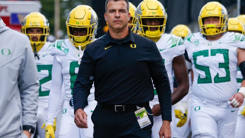 Nov 6, 2021; Seattle, Washington, USA; Oregon Ducks head coach Mario Cristobal walks with his players from the locker room before a game against the Washington Huskies at Alaska Airlines Field at Husky Stadium. Mandatory Credit: Joe Nicholson-USA TODAY Sports