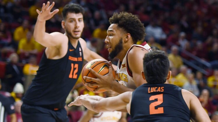 Iowa State's forward George Conditt(4) drives to the basket between Oregon State's center Roman Silva(12) and guard Jarod Lucas(2) during the first half at Hilton Coliseum Friday, Nov. 12, 2021, in Ames, Iowa.