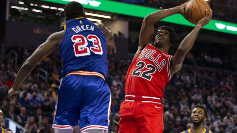 Nov 12, 2021; San Francisco, California, USA; Chicago Bulls forward Alize Johnson (22) shoots around Golden State Warriors forward Draymond Green (23) during the second quarter at Chase Center. Mandatory Credit: D. Ross Cameron-USA TODAY Sports