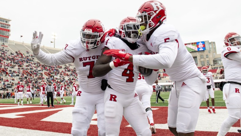 Nov 13, 2021; Bloomington, Indiana, USA; The Rutgers Scarlet Knights celebrate a touchdown by running back Aaron Young (4) during the second half against the Indiana Hoosiers at Memorial Stadium. The Scarlet Knights won 38-3.  Mandatory Credit: Marc Lebryk-USA TODAY Sports