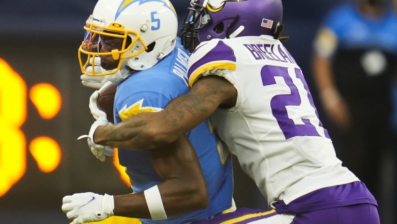 Nov 14, 2021; Inglewood, California, USA; Minnesota Vikings cornerback Bashaud Breeland (21) tackles Los Angeles Chargers wide receiver Josh Palmer (5) after a short gain in the fourth quarter at SoFi Stadium. Mandatory Credit: Robert Hanashiro-USA TODAY Sports